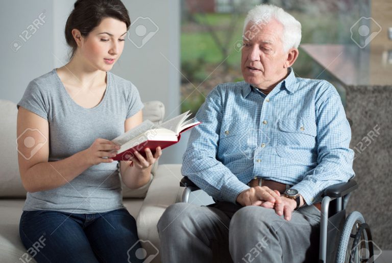 34424889-Senior-care-assistant-reading-book-elderly-man-Stock-Photo